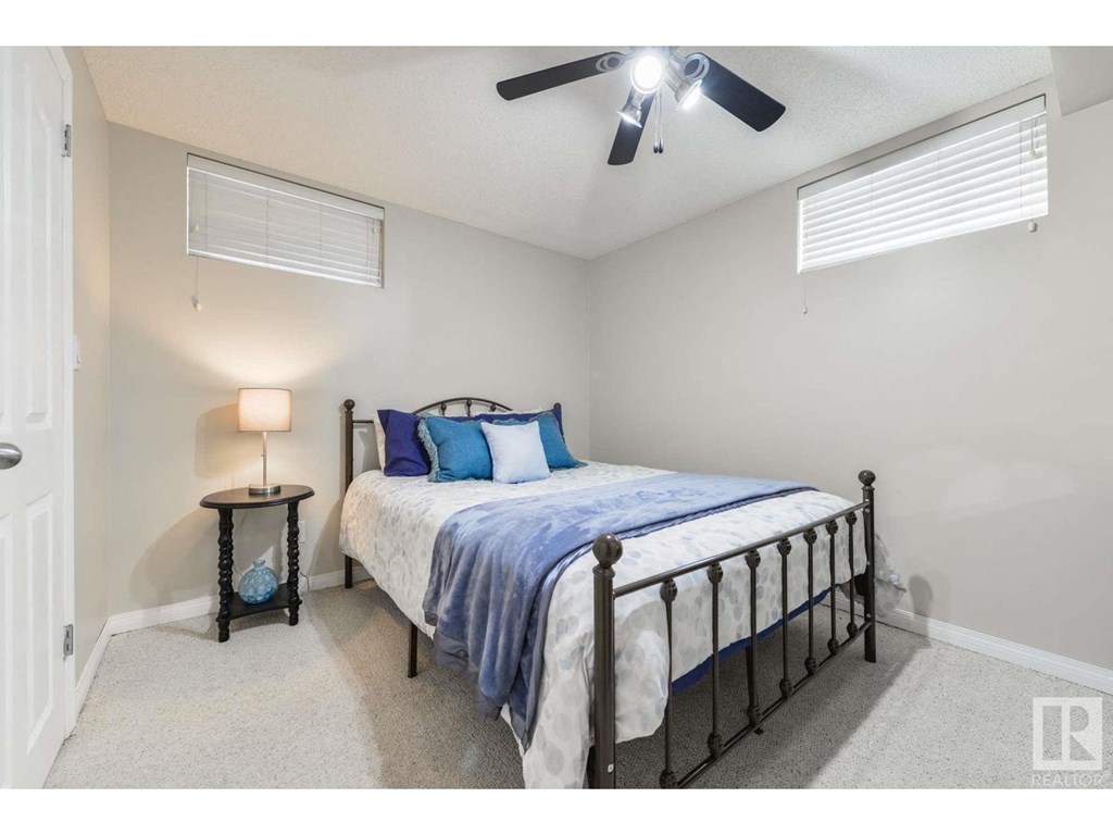 a bedroom with a bed and a ceiling fan
