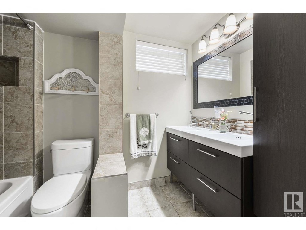 a bathroom with a toilet sink and a mirror