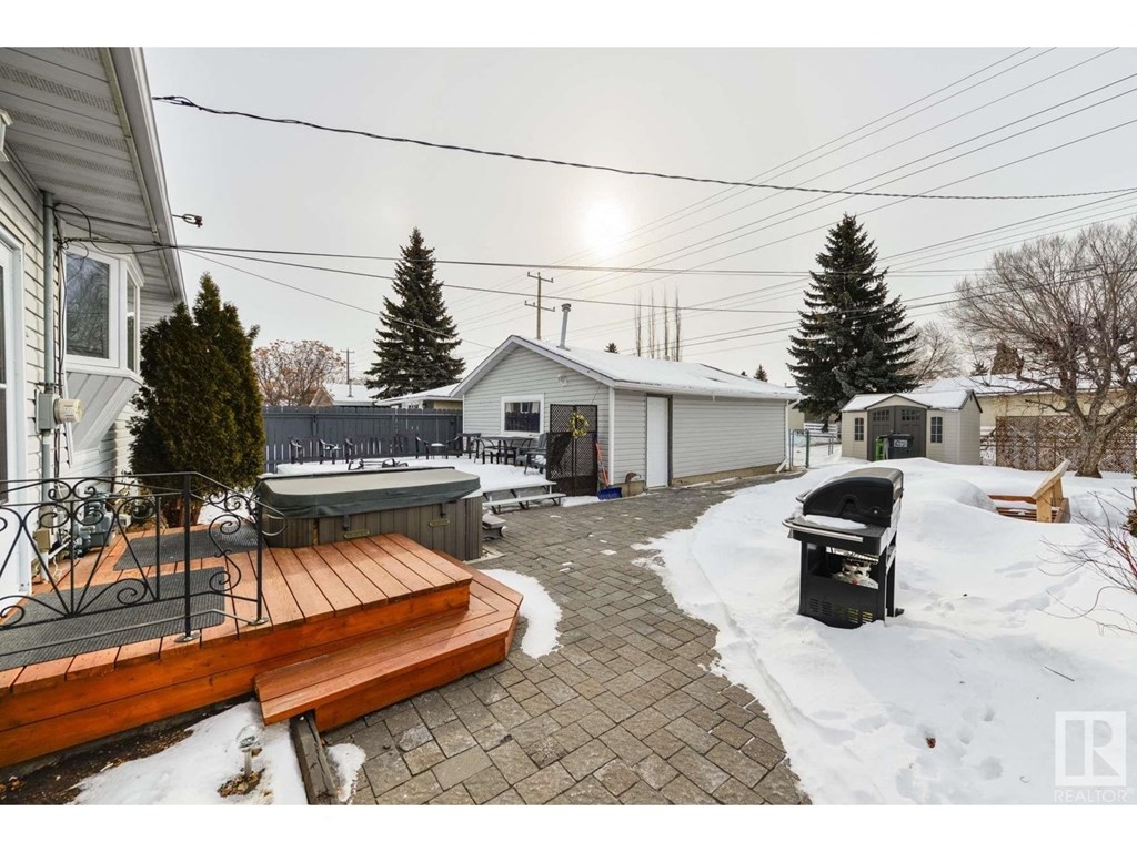 a backyard with a deck and a grill in the snow