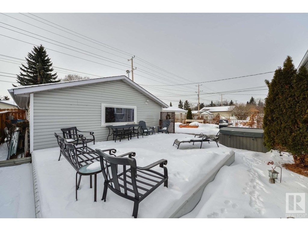 a patio with tables and chairs in the snow