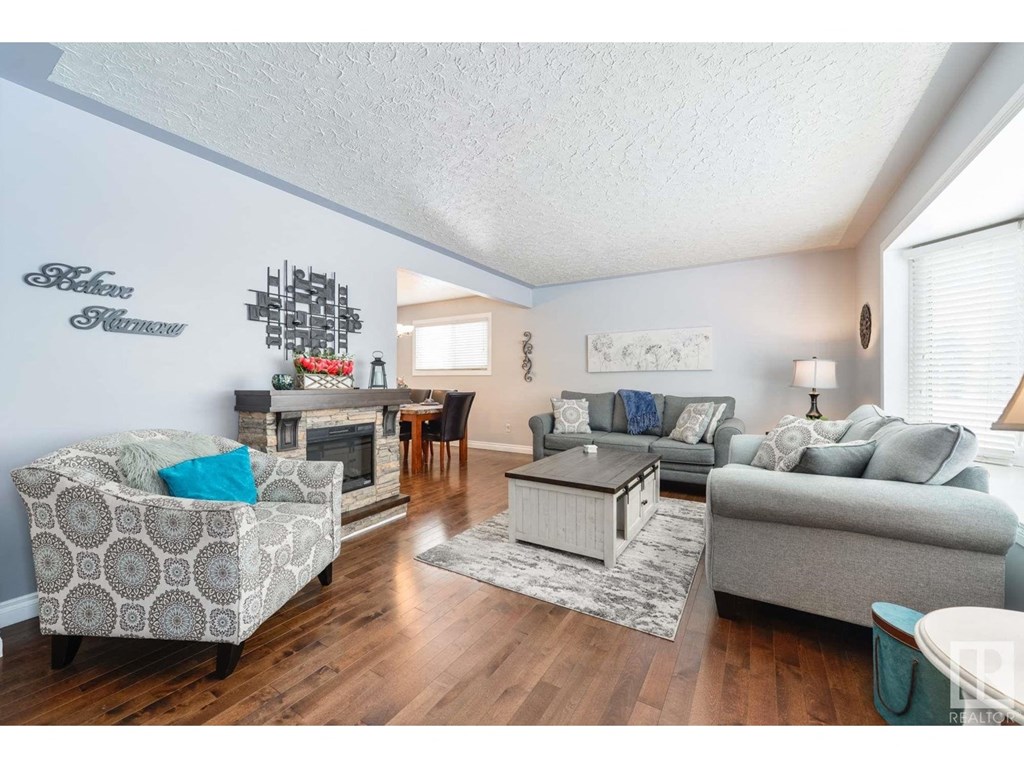 a living room with couches and chairs and a table