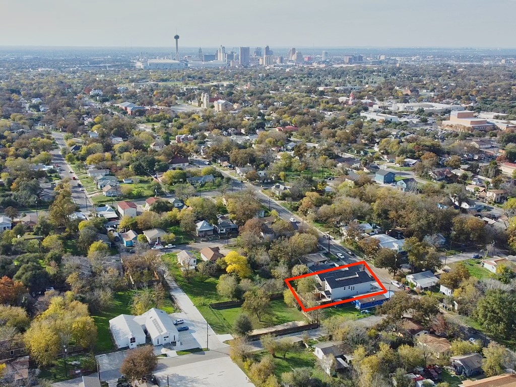 an aerial view of a neighborhood with a city in the background