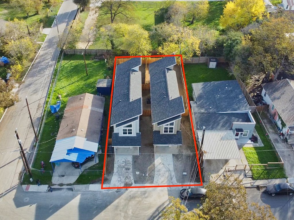 an aerial view of a house with a red box around it and a yard with