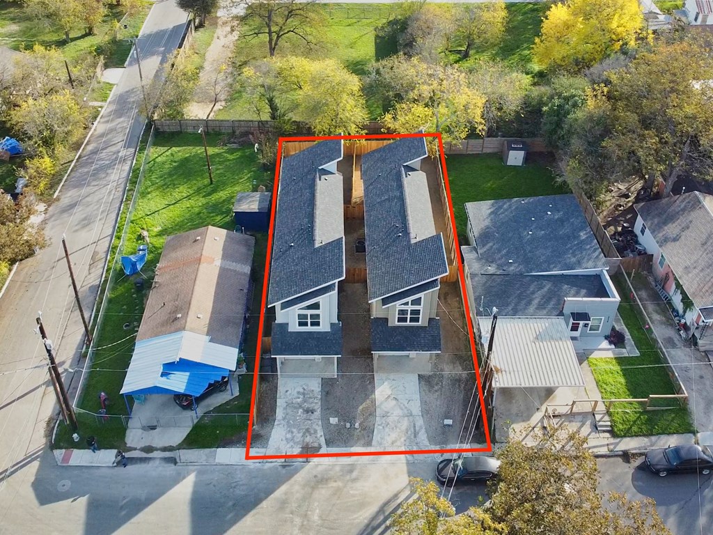 an aerial view of a house with a red box around it and a yard with