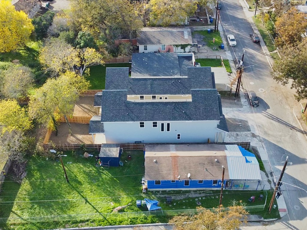 a birds eye view of a house with a white roof and a blue garage