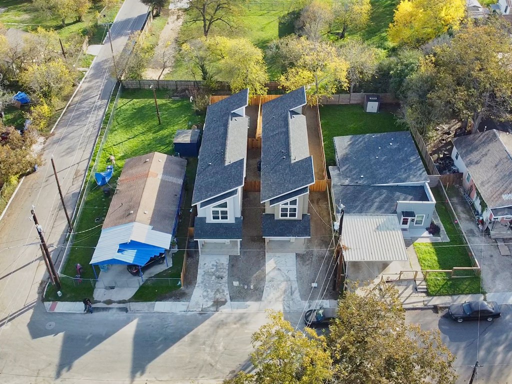 a birds eye view of three houses from the sky