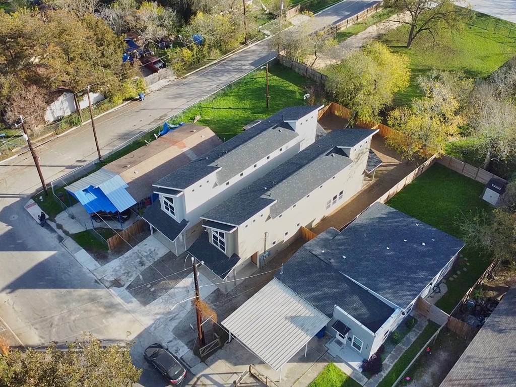 an aerial view of a house and a church from the sky