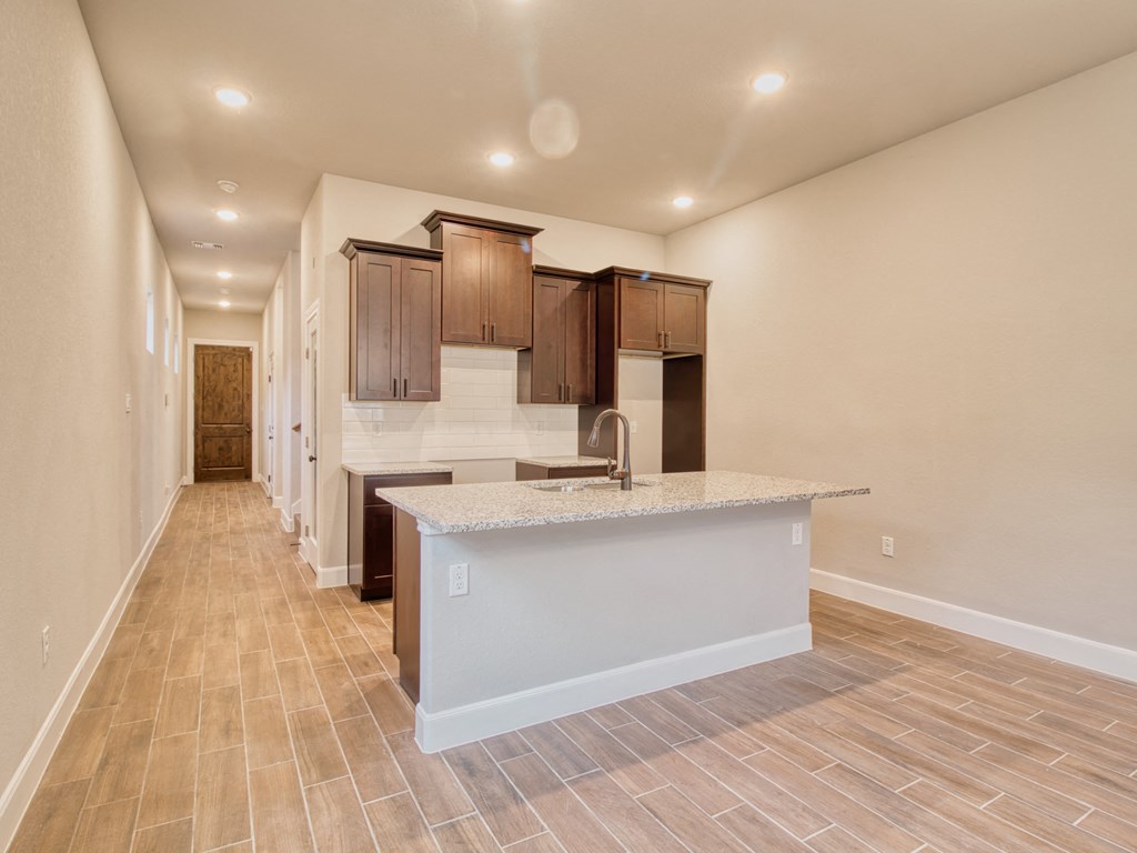 a kitchen with a sink and a counter top in a house