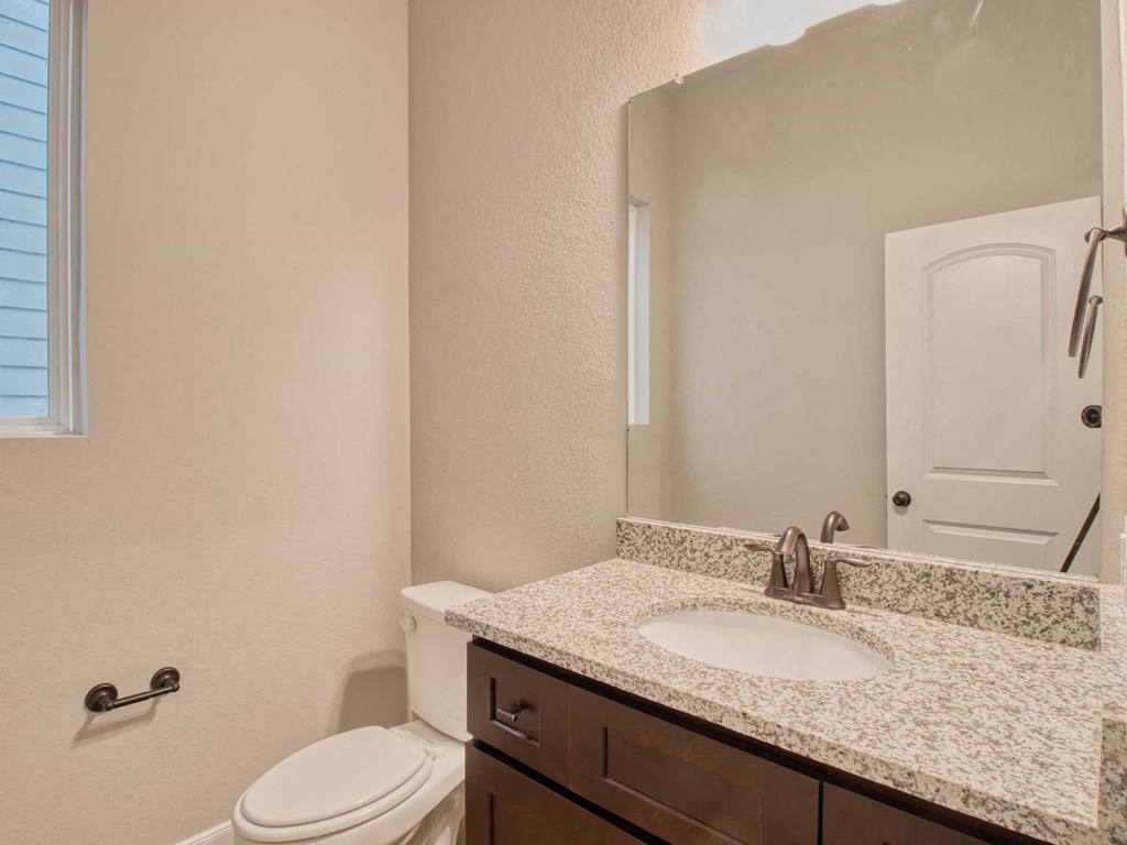 a bathroom with a sink and a toilet and a mirror