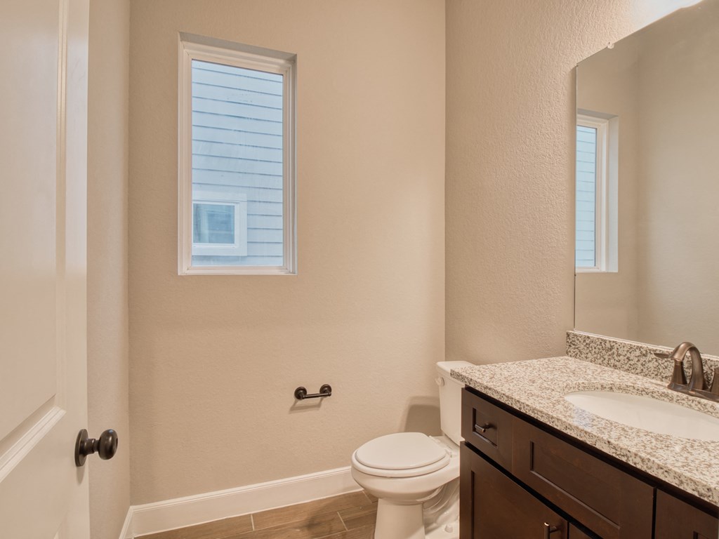 a bathroom with a toilet and a sink and a mirror
