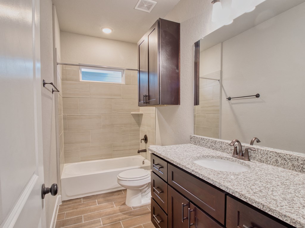 a bathroom with a sink and a toilet and a shower
