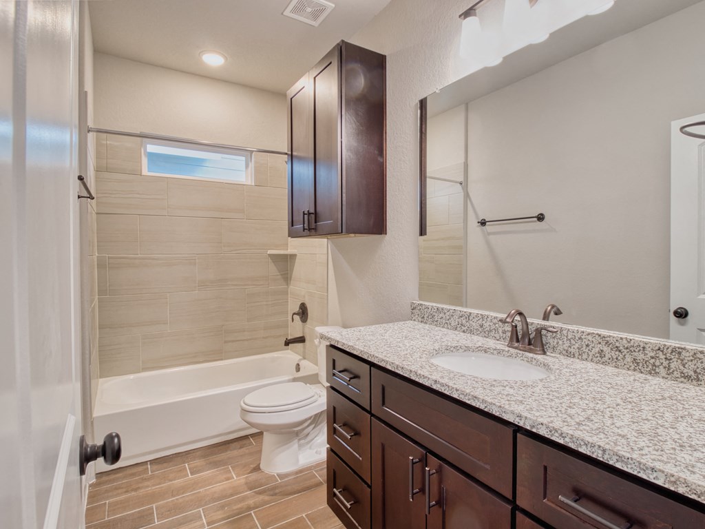 a bathroom with a sink and a toilet and a shower