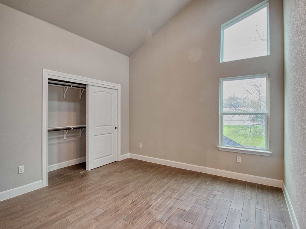 an empty room with a closet and a window
