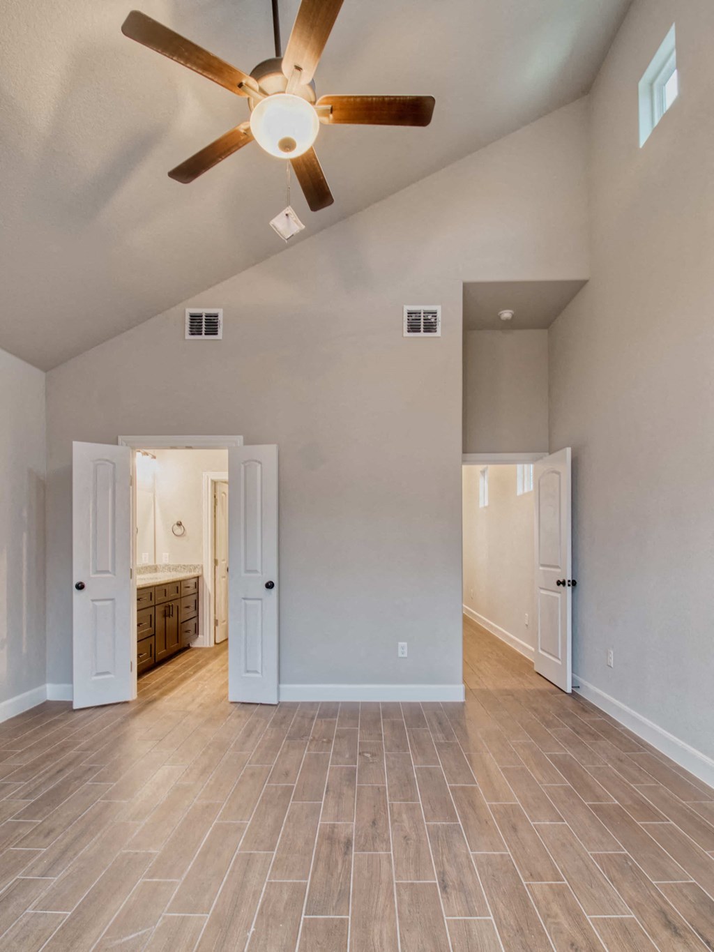 the spacious living room is open to the kitchen and dining room