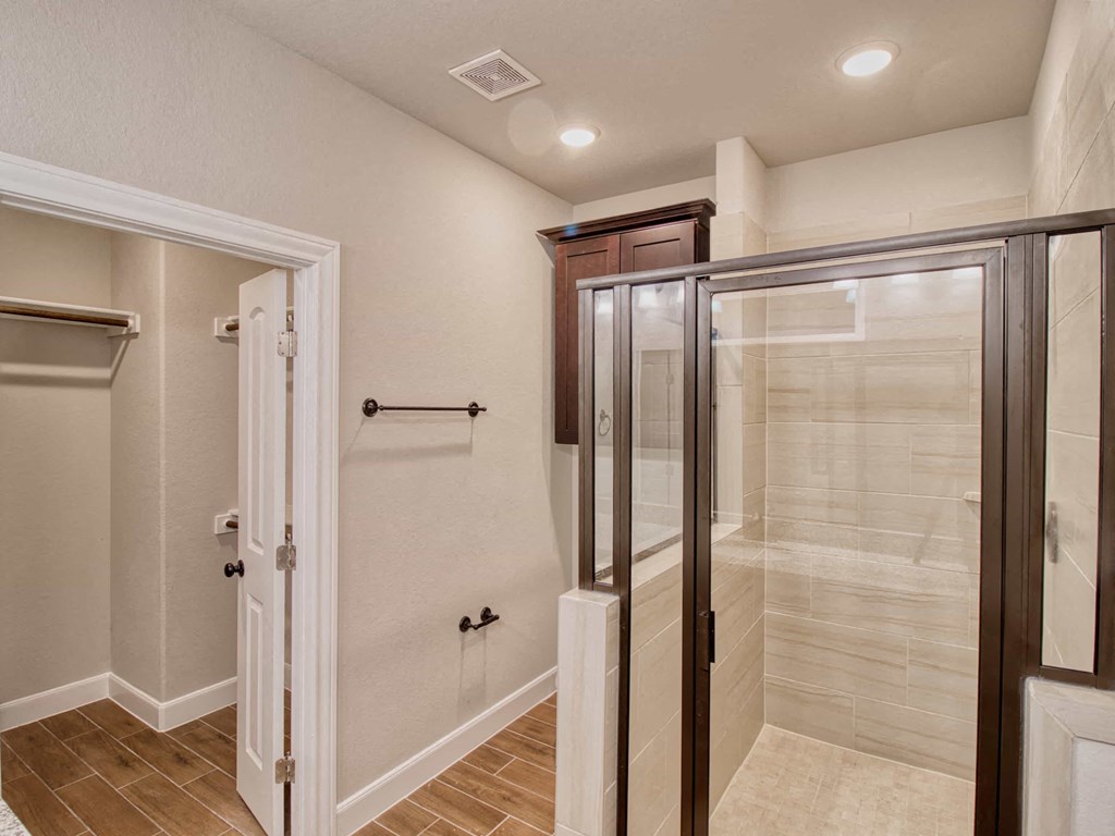 a bathroom with a shower and a closet