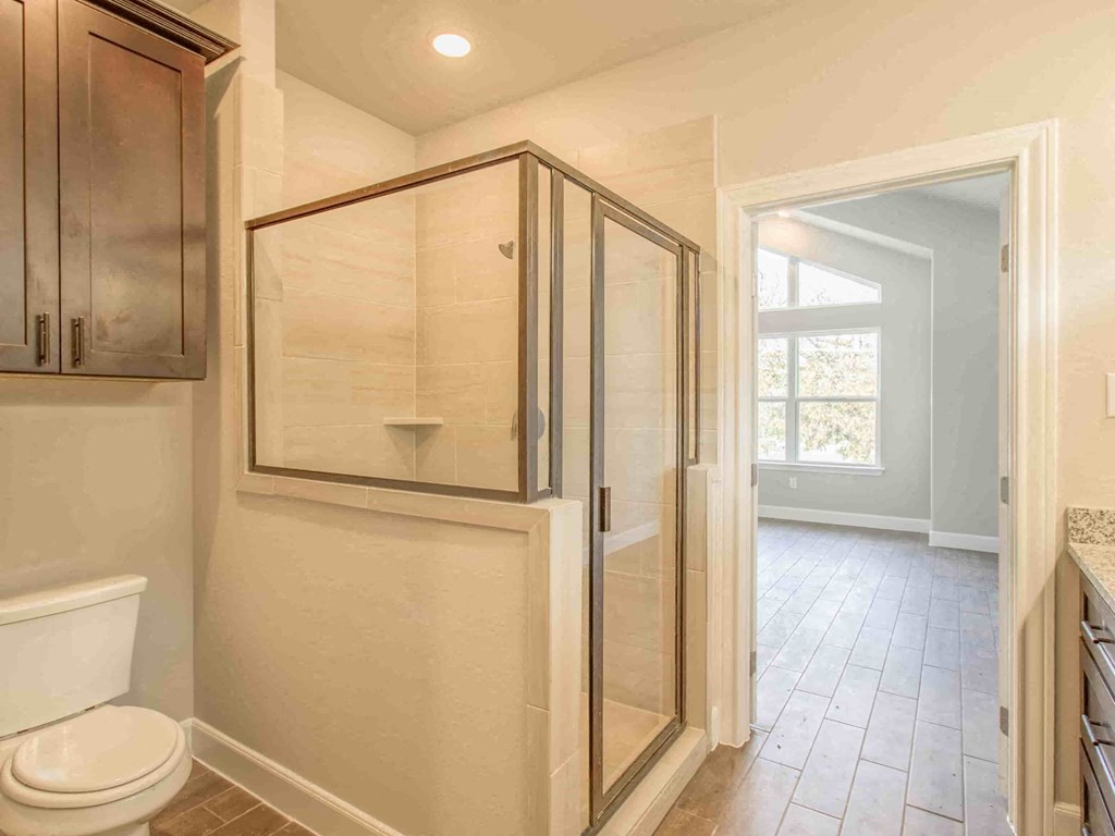 a small bathroom with a shower and a toilet