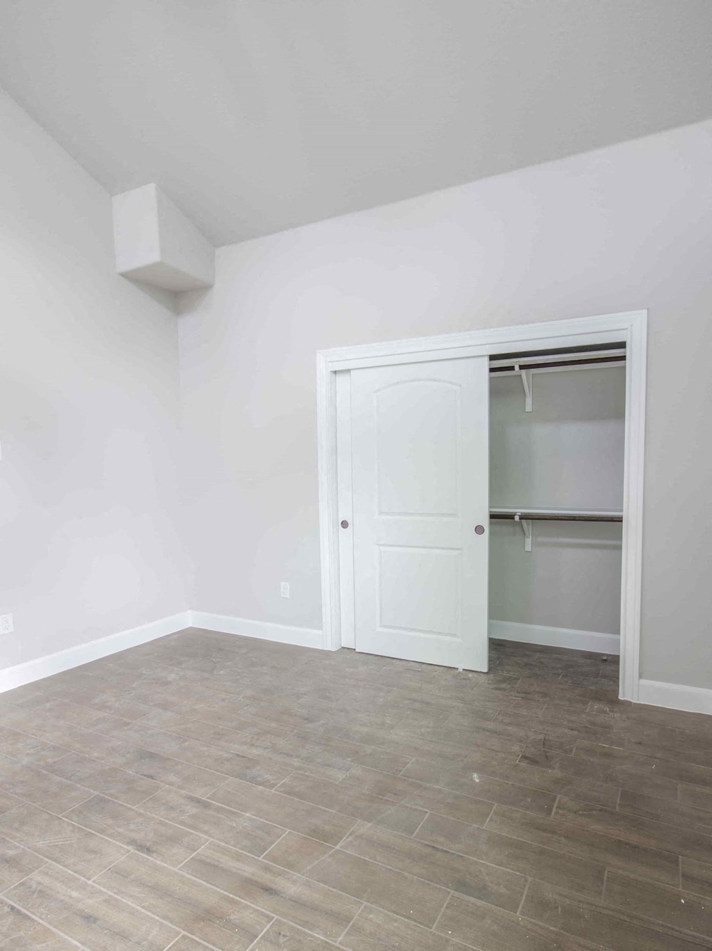 an empty room with a closet and a tile floor