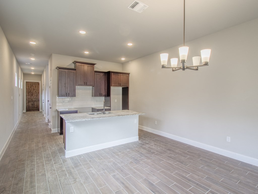 the great room and kitchen of a new home