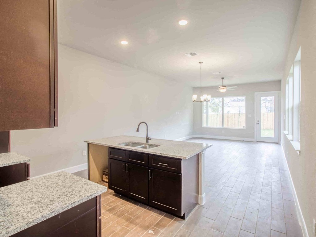 an empty kitchen and living room with an open floor plan