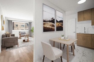 a living room and a kitchen with a table and chairs