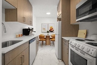 a kitchen with a stove refrigerator and a sink