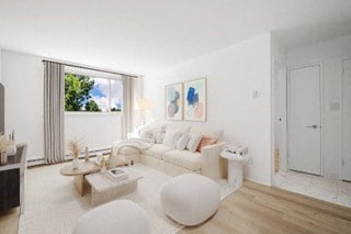 a living room with white furniture and a large window