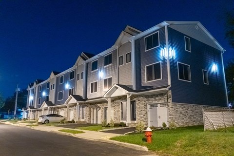 A building with blue lights on the front at night.