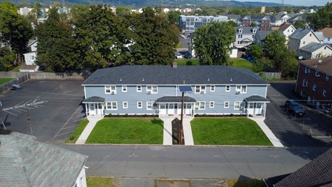 A large building with a parking lot in front of it.