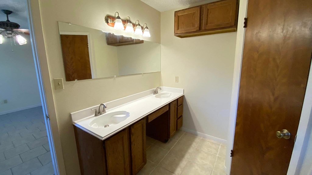 a bathroom with two sinks and a mirror