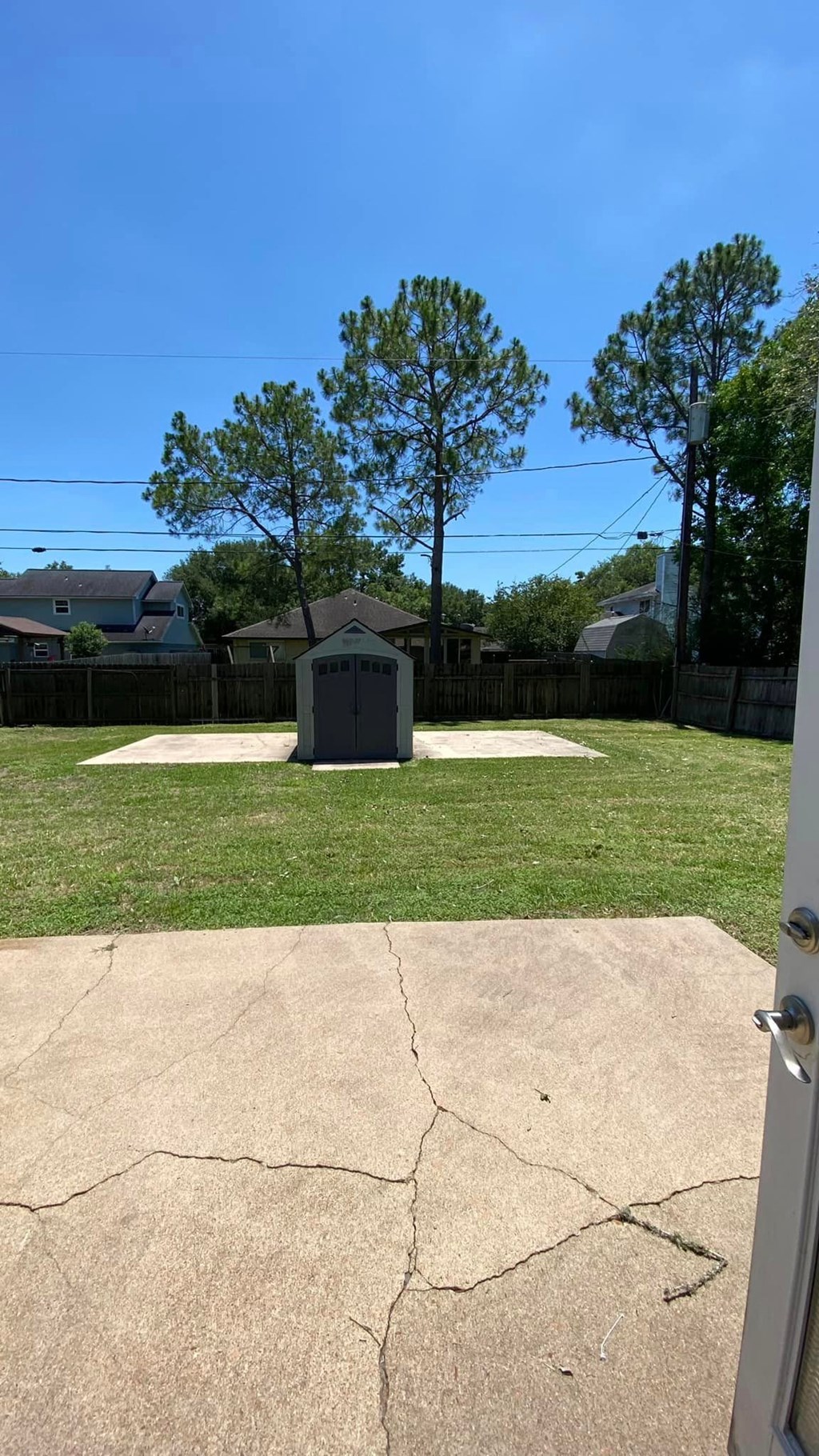 a backyard with a pool and a gazebo in the grass