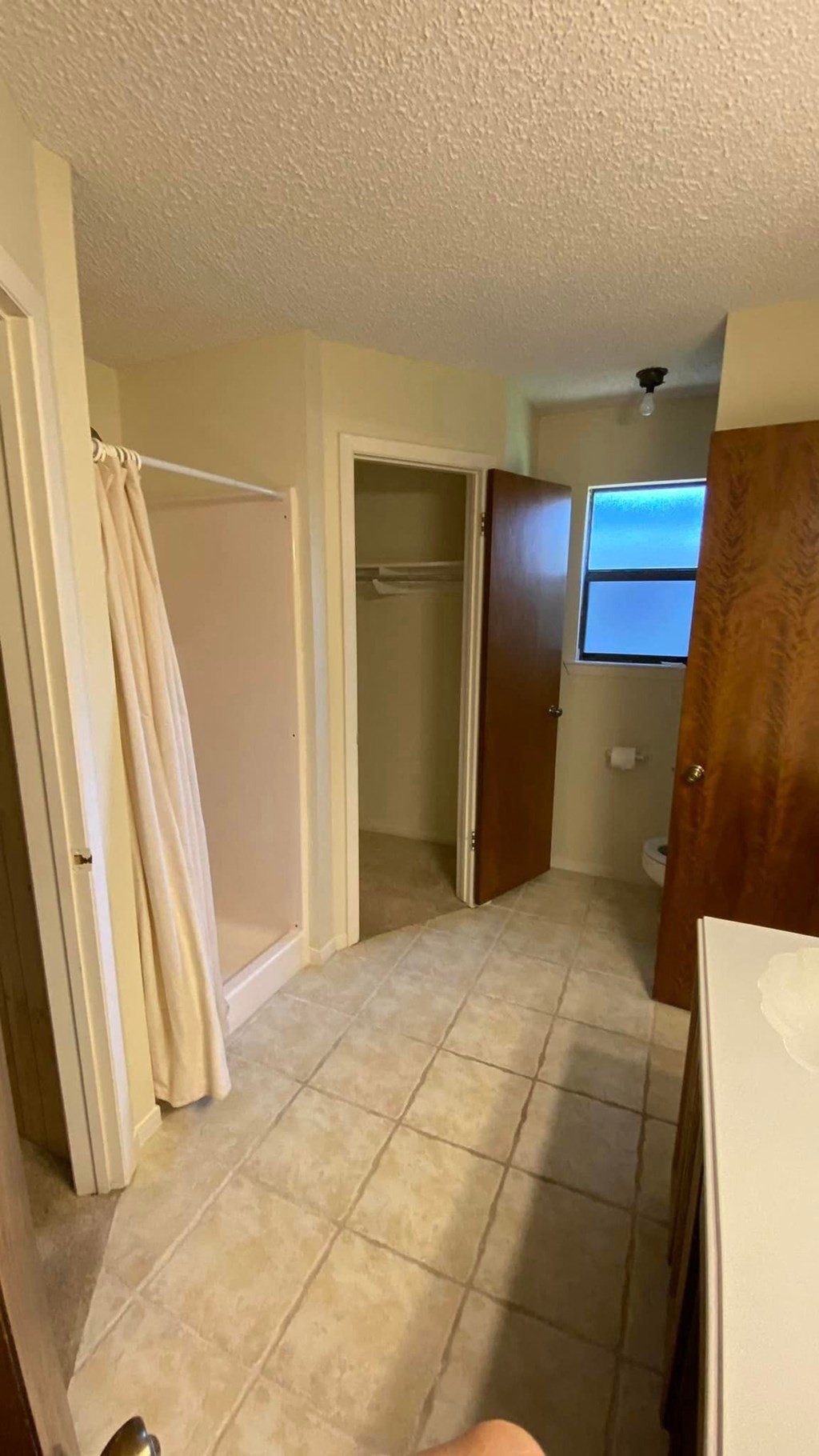 a bathroom with a shower and a toilet in it