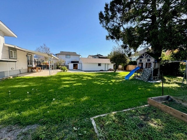 a backyard with a play yard and a slide