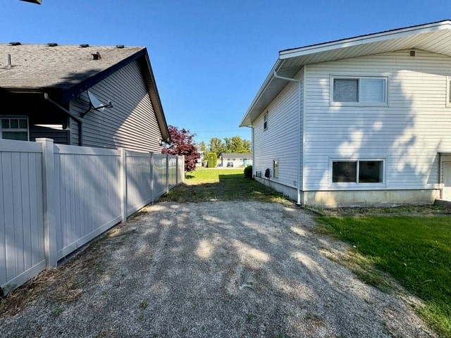 a white house and a white fence and a driveway