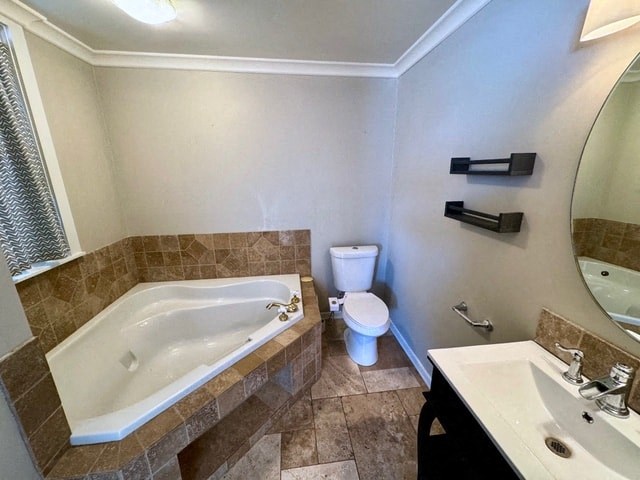 a bathroom with a tub and a toilet and a sink