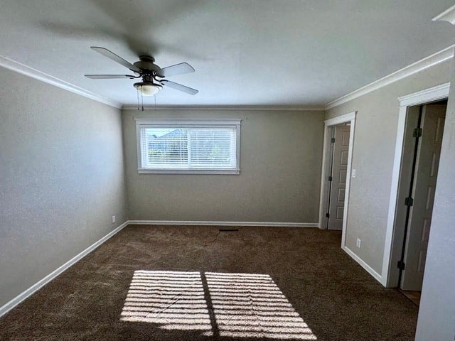 an empty room with a ceiling fan and a window