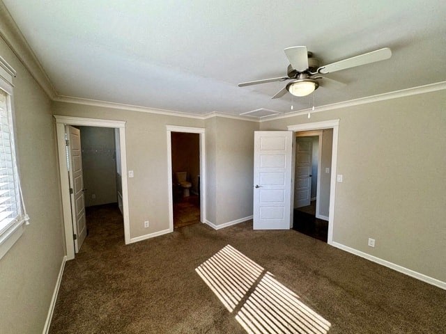 an empty living room with a ceiling fan