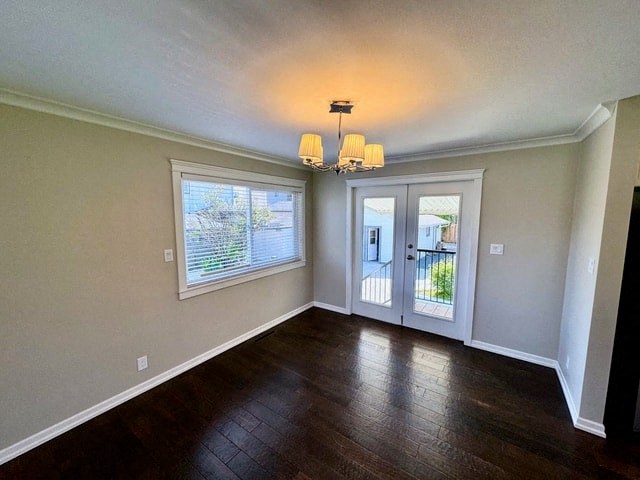 an empty living room with wood floors and a door to a balcony