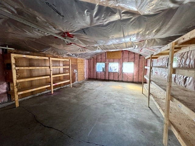 the inside of a building with wooden stalls and a tarp on the ceiling