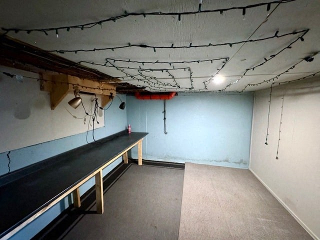 a room with a table and wires hanging from the ceiling