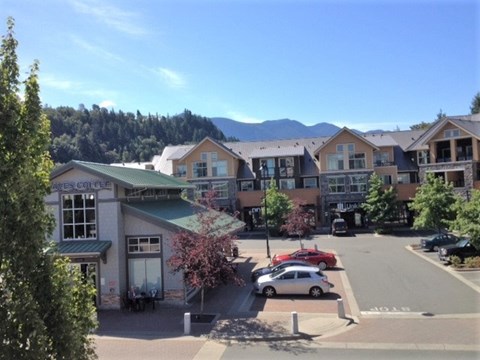 an aerial view of an apartment complex with cars parked in a parking lot