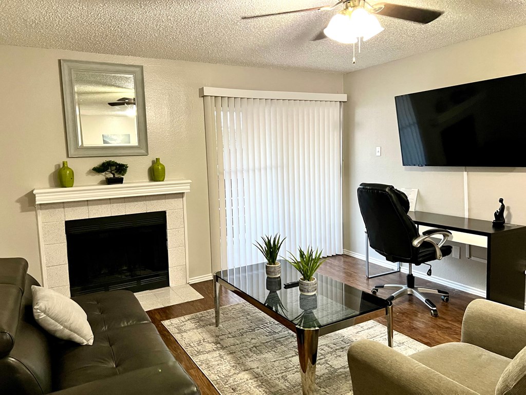 a living room with a couch and a table and a fireplace