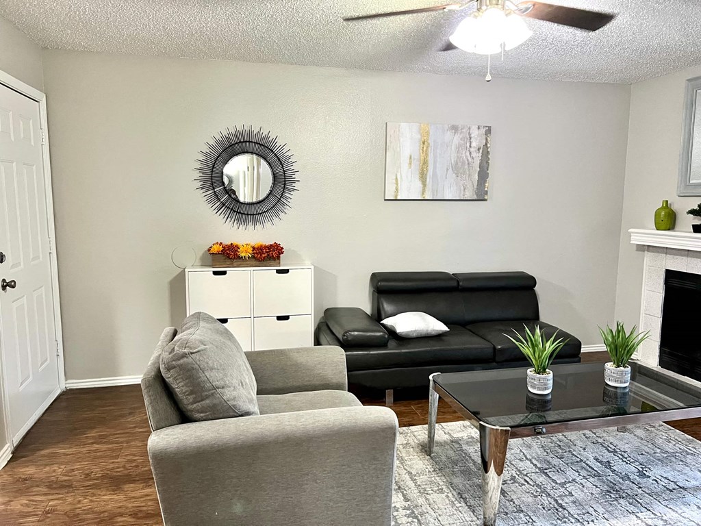 a living room with a couch and a chair and a table