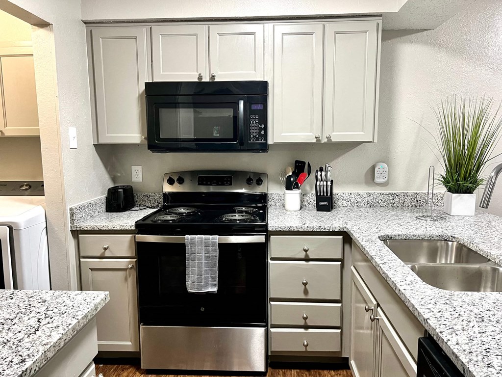 a kitchen with a stove microwave and sink