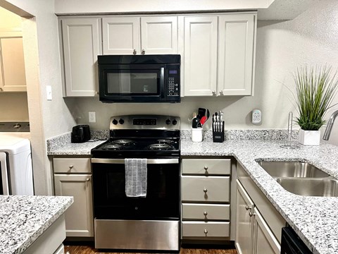 a kitchen with a stove microwave and sink