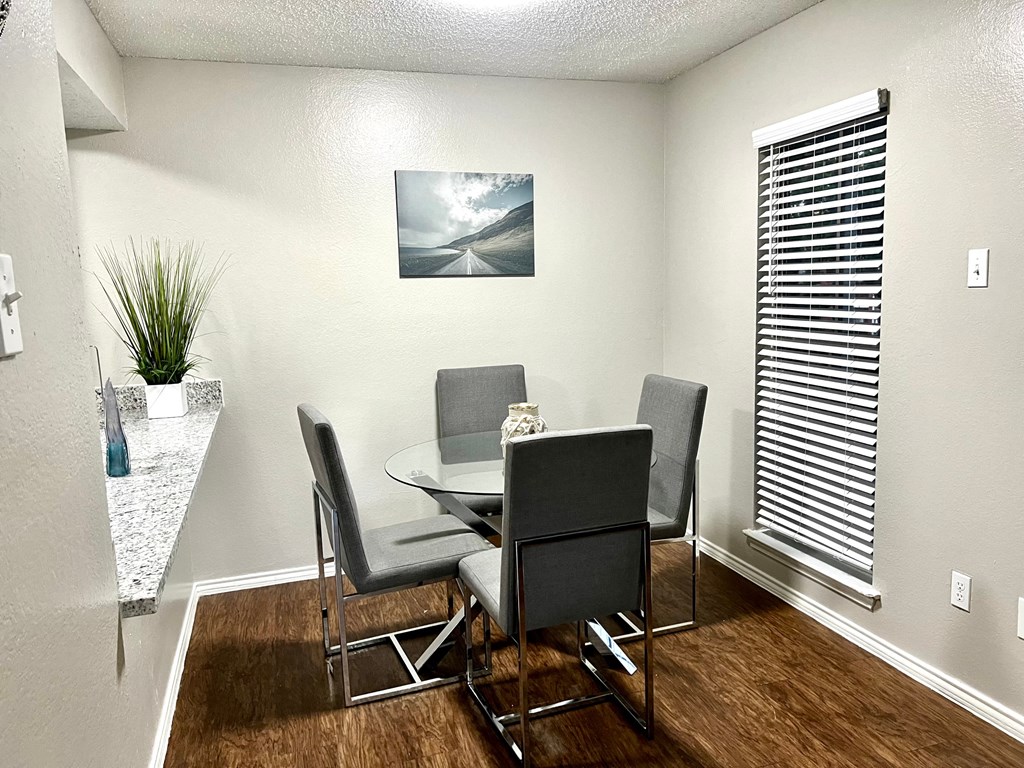 a dining room with a table and chairs