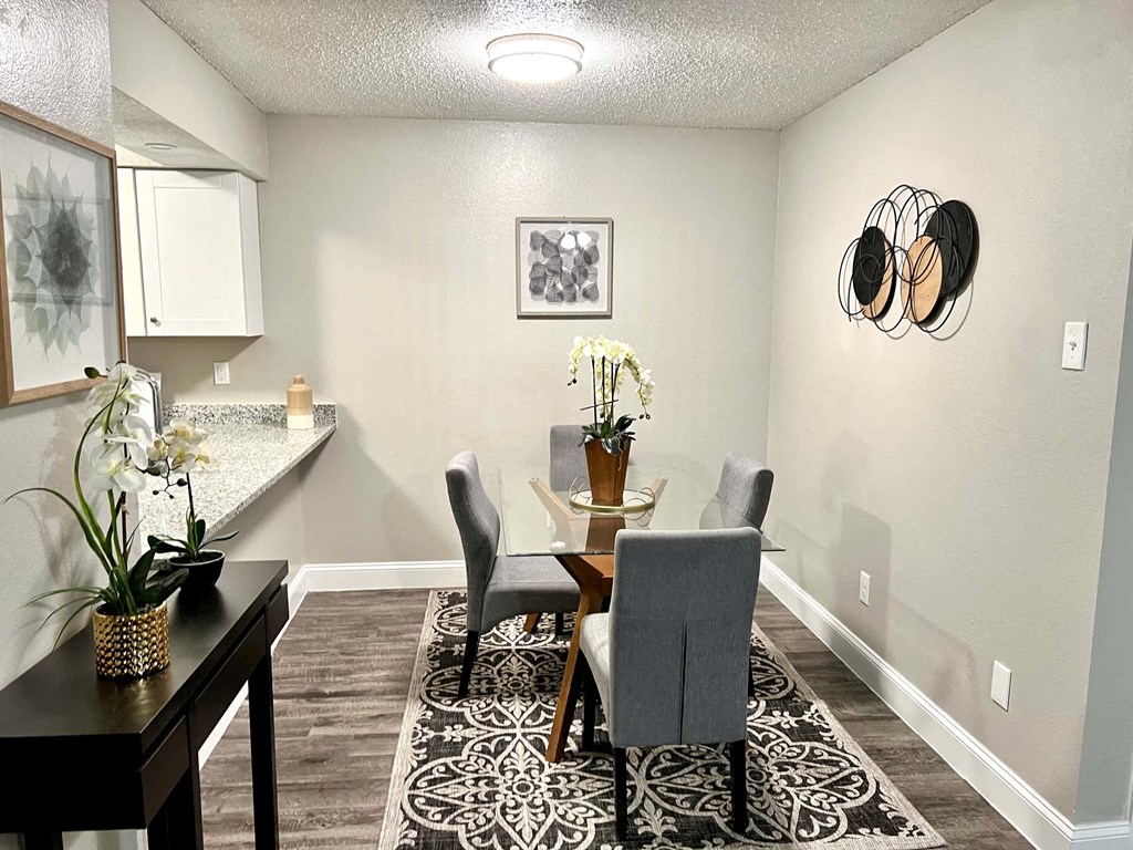a dining room with a table and chairs