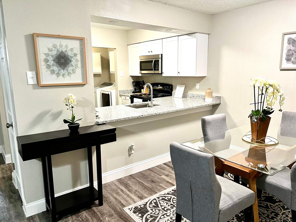 a kitchen and dining area with a table and chairs