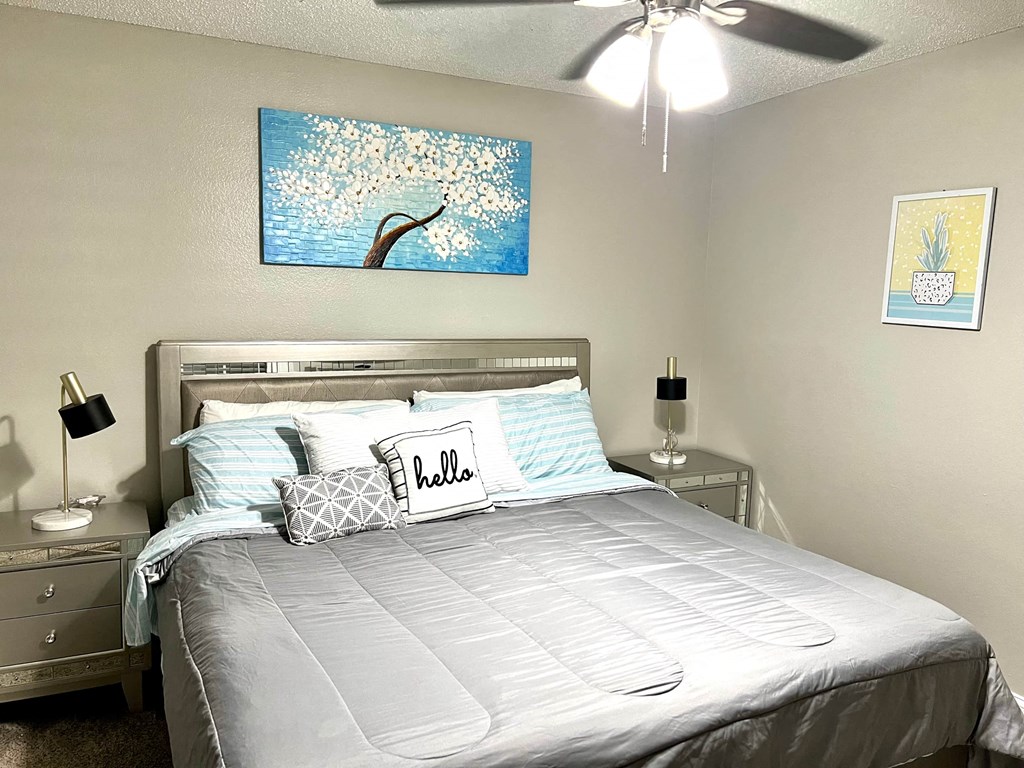 a bedroom with a bed and a ceiling fan