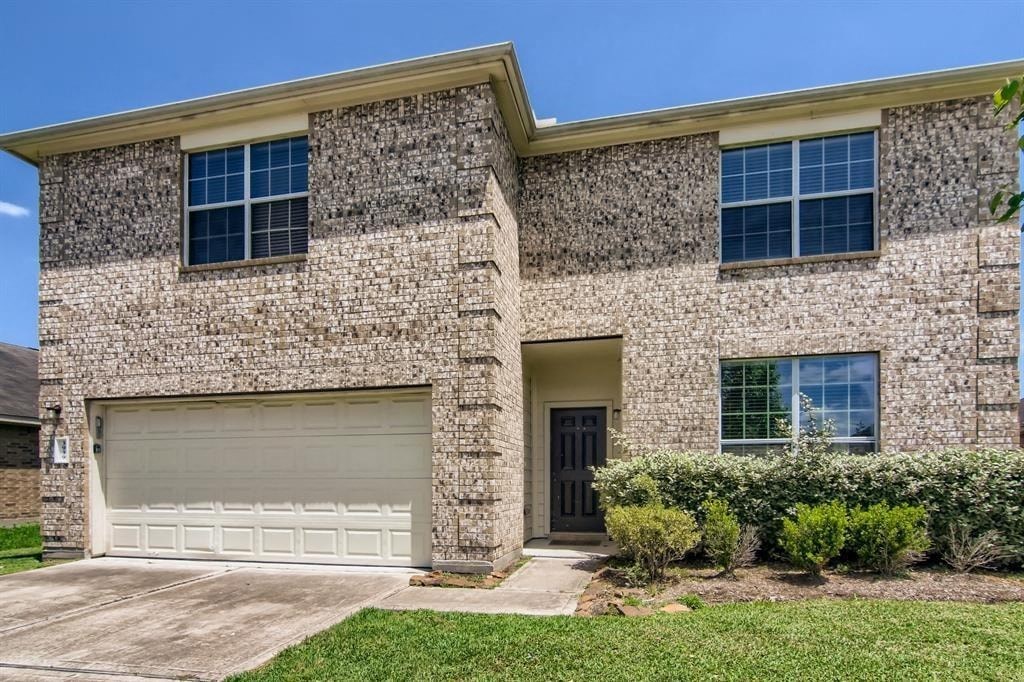 a house with a garage door in front of it