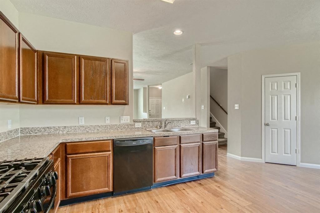 an empty kitchen with wood flooring and counter tops